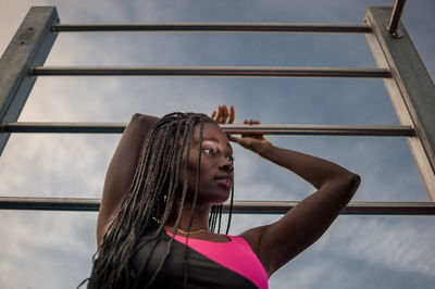 Low angle view of woman standing against the sky