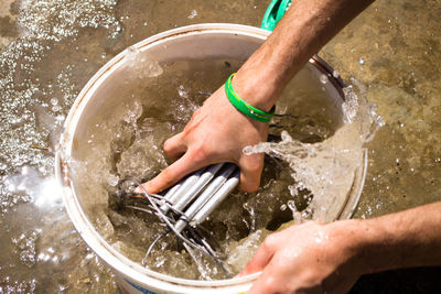 High angle view of hands splashing water