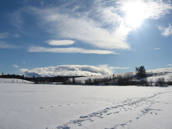 Snow covered landscape against sky