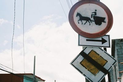 Low angle view of road sign against sky