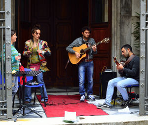 People playing guitar at music concert