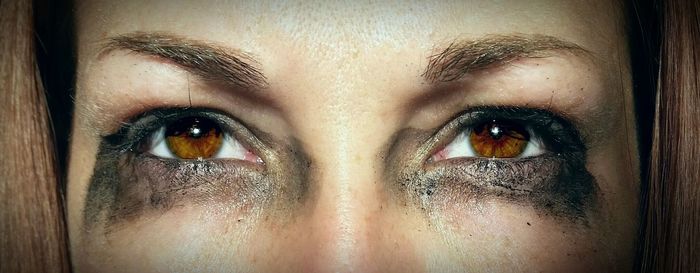 Close-up of woman with smudged mascara