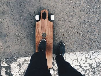 Low section of person standing on road