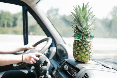 Cropped image of woman driving car