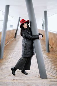 Full length portrait of woman standing on floor