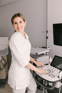 Portrait of young woman standing in office