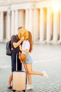 A young couple of travellers hugging in the city and enjoying romance. lovers kiss. tourism, travel