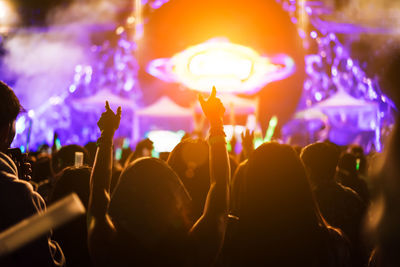 Rear view of people enjoying at music concert