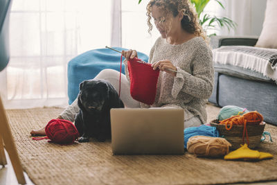 Man with dog sitting at home
