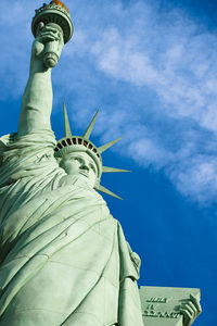 Low angle view of statue against cloudy sky