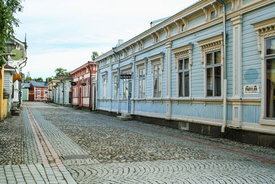 Street amidst buildings in city against sky