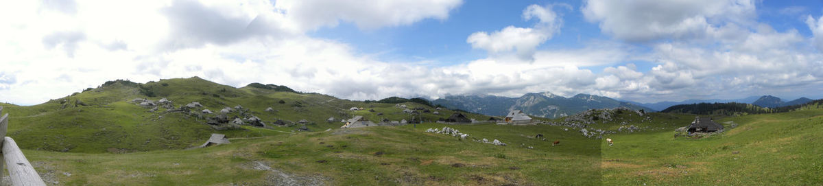 Scenic view of mountains against cloudy sky