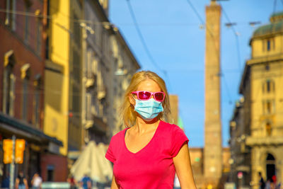 Portrait of woman standing in city