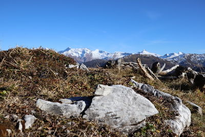 Scenic view of snowcapped mountains against blue sky