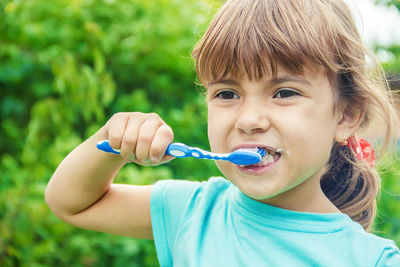 Close-up of girl blowing bubbles