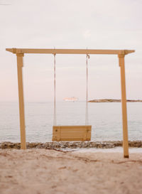 Lifeguard hut on beach against sky