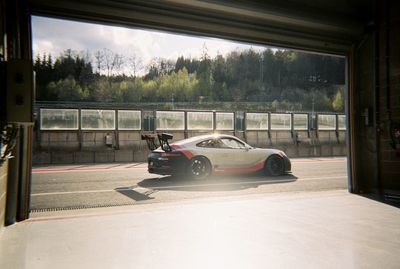 Car on road seen through window