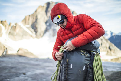 Midsection of man with snow on mountain