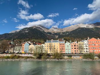 River by townscape against sky