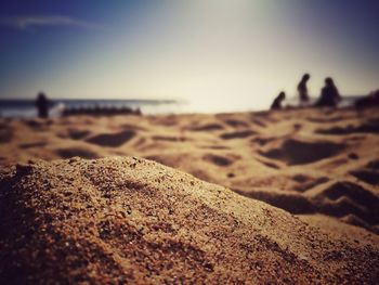 Close-up of sand on beach against sky