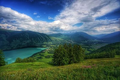 Scenic view of mountains against cloudy sky