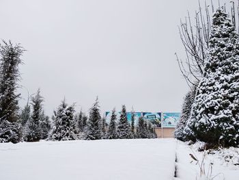 Snow covered field against clear sky