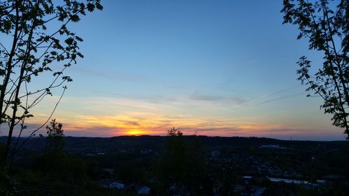 Scenic view of landscape against sky at sunset