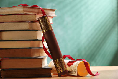 Close-up of books stacked against wall