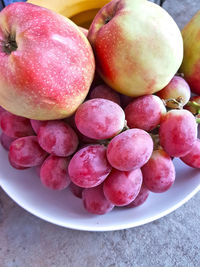 High angle view of grapes in bowl on table