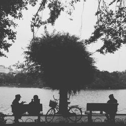 People relaxing on lakeshore