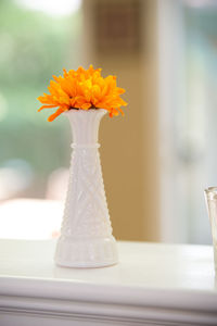 Close-up of white flower vase on table at home