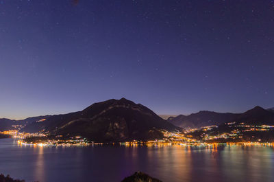 Scenic view of illuminated mountains against sky at night