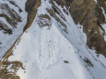 High angle view of snow covered mountain with avalanche in spring 