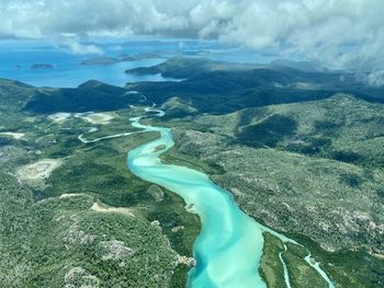 High angle view of sea and landscape against sky