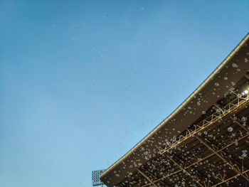 Low angle view of buildings against clear blue sky