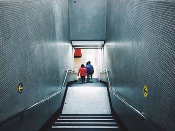 Rear view of people on staircase in subway