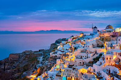 High angle view of townscape by sea against sky