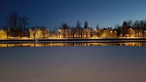 Reflection of building in water at night