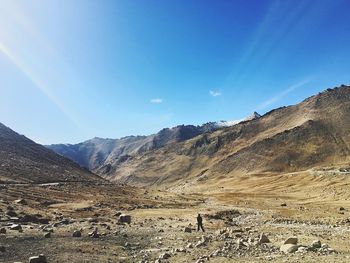 Scenic view of mountains against blue sky