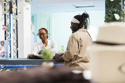 Female doctor examining patient at home