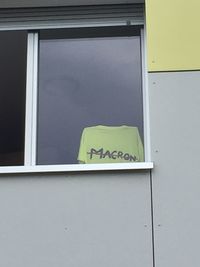 Low angle view of text on window of building