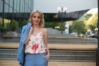 Portrait of smiling young woman standing outdoors