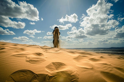 Man in the desert, happy and jumps, jumping in the desert celebrating her freedom