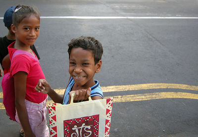 Portrait of a smiling girl with road