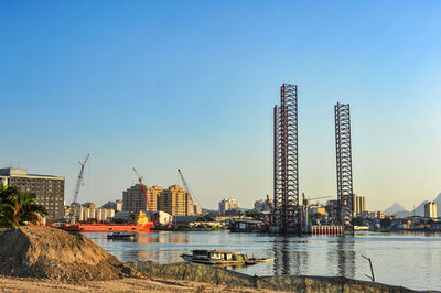 Commercial dock at harbor against clear sky