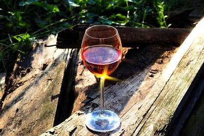 Close-up of wine glasses on wood