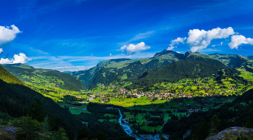 Panoramic view of landscape and mountains against blue sky