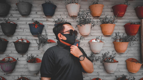 High angle view of man standing on potted plant