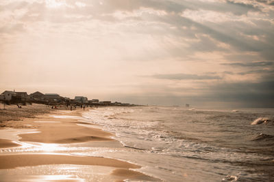 Scenic view of beach against sky during sunset