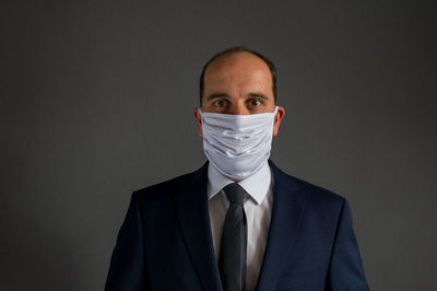 Portrait of mid adult man against black background